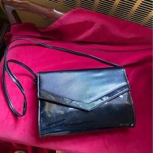 Shiny black vinyl cross body purse. Great day or night. Essential for every girl